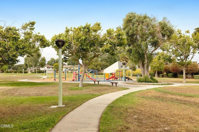 view of home's community with playground community and a yard