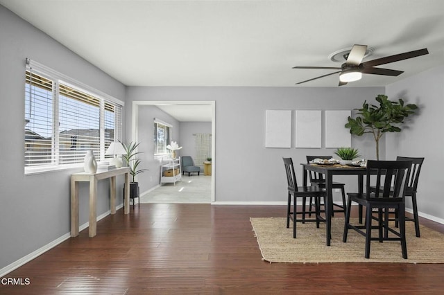 dining space with ceiling fan, baseboards, and wood finished floors