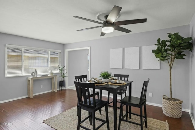 dining area featuring ceiling fan, baseboards, and wood finished floors