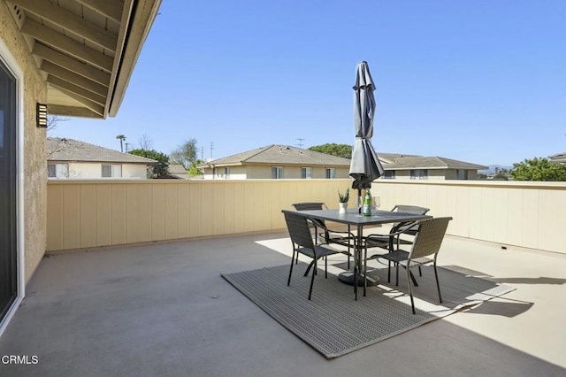 view of patio featuring fence and outdoor dining space