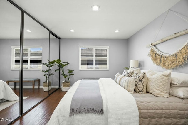 bedroom featuring baseboards, wood finished floors, and recessed lighting