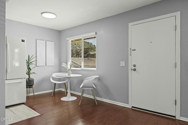 dining room featuring baseboards and wood finished floors