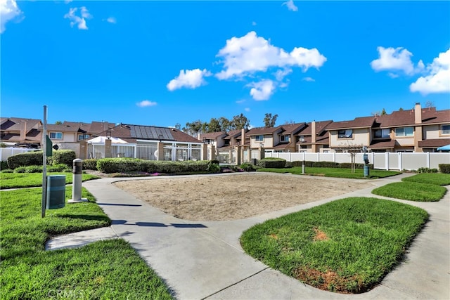 surrounding community with a yard, a residential view, and fence