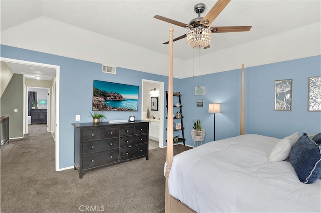 carpeted bedroom with ceiling fan, visible vents, baseboards, vaulted ceiling, and ensuite bath