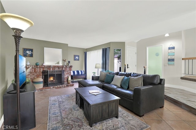 living room with light tile patterned floors, stairway, a fireplace, and baseboards