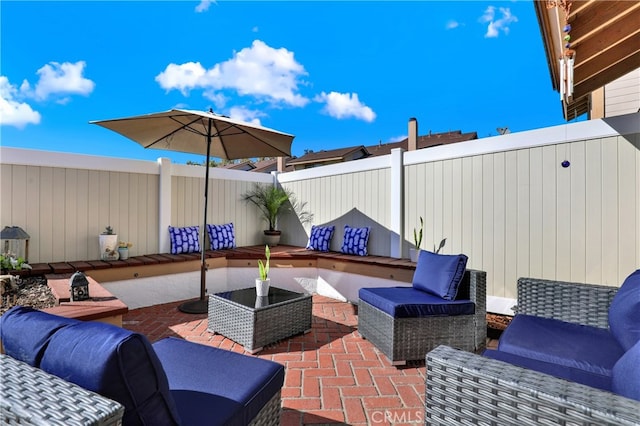 view of patio / terrace featuring outdoor lounge area and fence