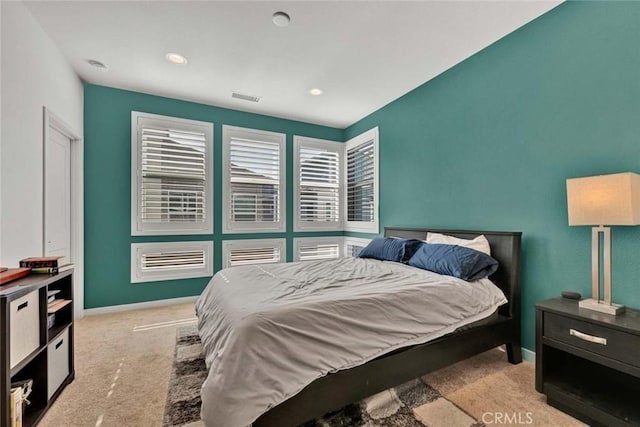 carpeted bedroom with multiple windows, recessed lighting, visible vents, and baseboards