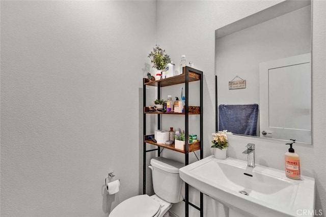 bathroom featuring a sink and toilet