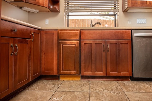 kitchen featuring brown cabinets, light countertops, and stainless steel dishwasher