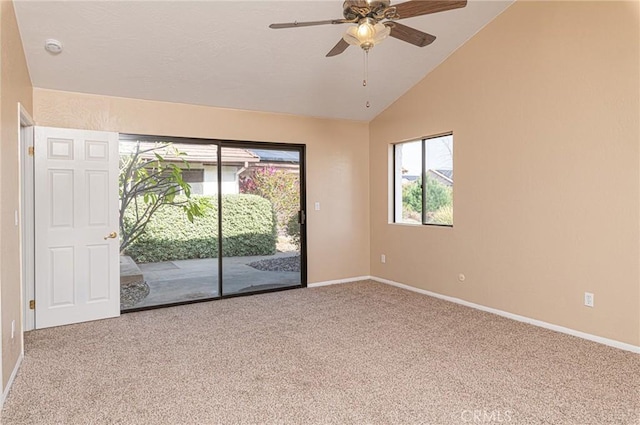 carpeted empty room with lofted ceiling, ceiling fan, and baseboards