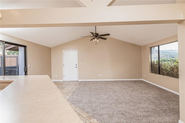 unfurnished living room with light carpet, vaulted ceiling, baseboards, and a healthy amount of sunlight