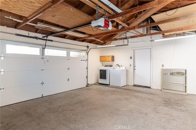 garage featuring a garage door opener and independent washer and dryer