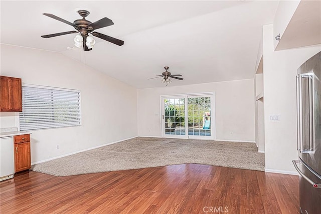 unfurnished living room featuring lofted ceiling, baseboards, a ceiling fan, and wood finished floors