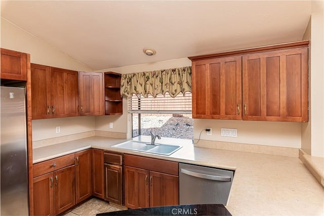 kitchen featuring appliances with stainless steel finishes, vaulted ceiling, light countertops, open shelves, and a sink