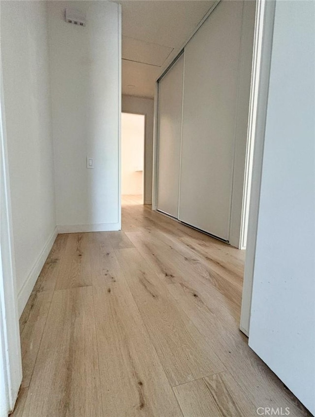 empty room featuring light wood-style floors and baseboards