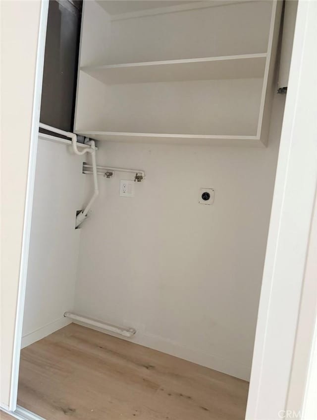 laundry area featuring hookup for an electric dryer, laundry area, washer hookup, baseboards, and light wood-style floors