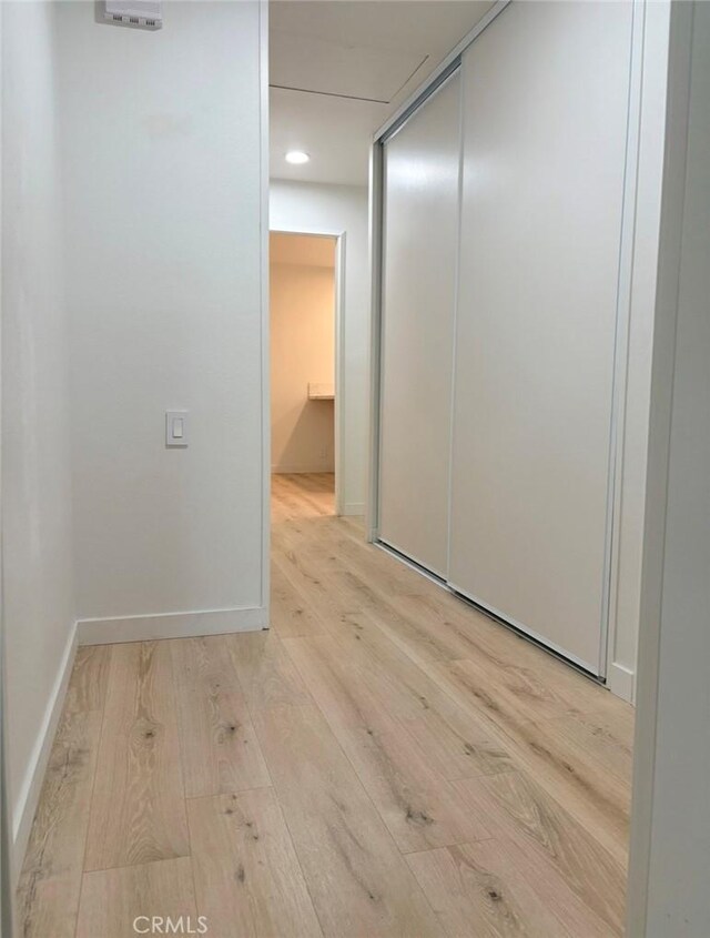 spare room featuring baseboards and hardwood / wood-style floors