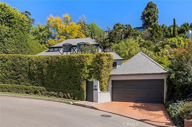 view of front of home featuring driveway, an attached garage, and stucco siding