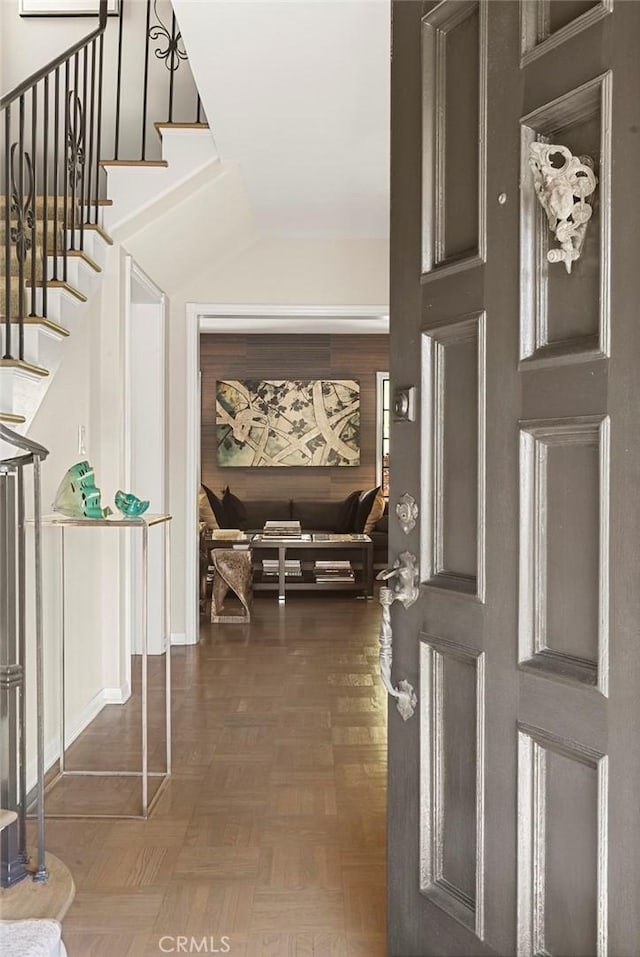 entryway featuring stairway and vaulted ceiling