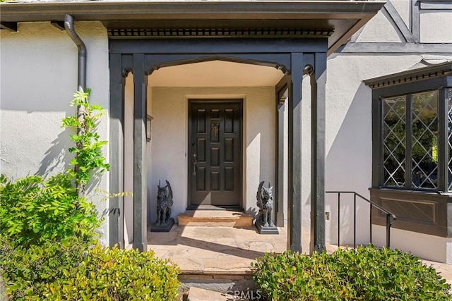 property entrance with stucco siding