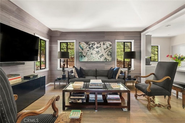 living area with baseboards and wood finished floors