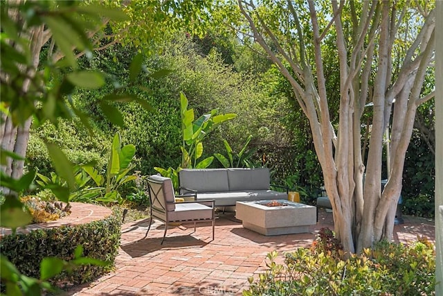 view of patio featuring an outdoor living space with a fire pit