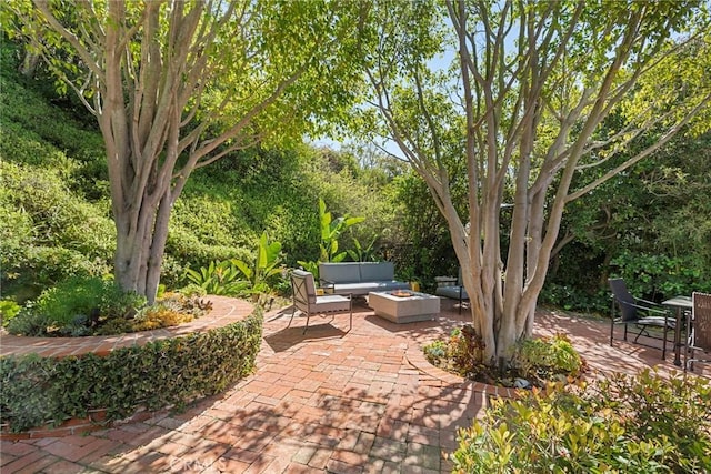 view of patio / terrace featuring an outdoor living space with a fire pit