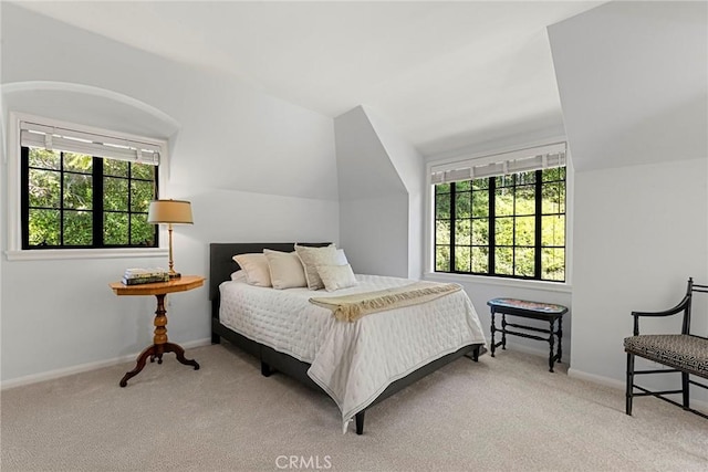 bedroom with multiple windows, carpet flooring, and baseboards