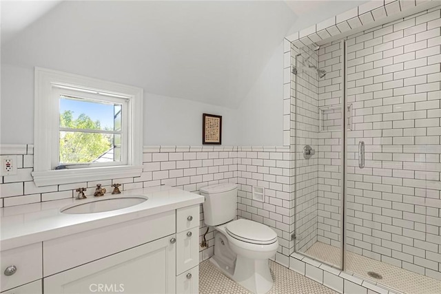 full bath featuring toilet, tile patterned floors, vaulted ceiling, a shower stall, and tile walls