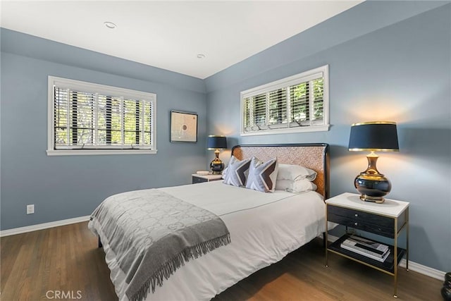 bedroom with baseboards and wood finished floors