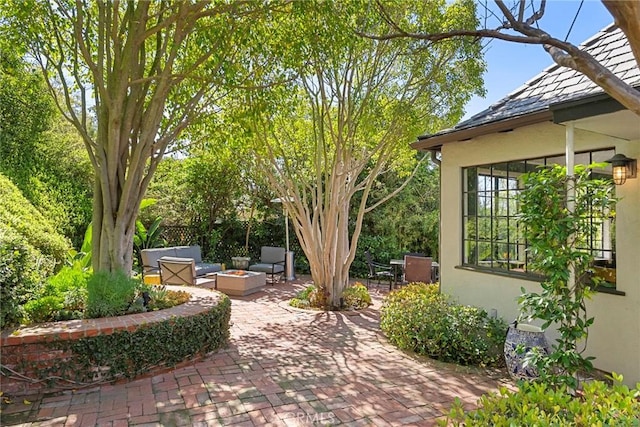 view of patio / terrace with an outdoor living space with a fire pit