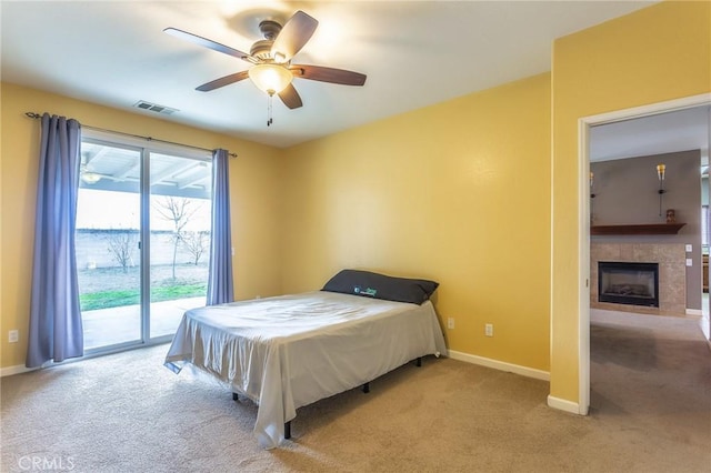 carpeted bedroom featuring a fireplace, visible vents, a ceiling fan, access to outside, and baseboards