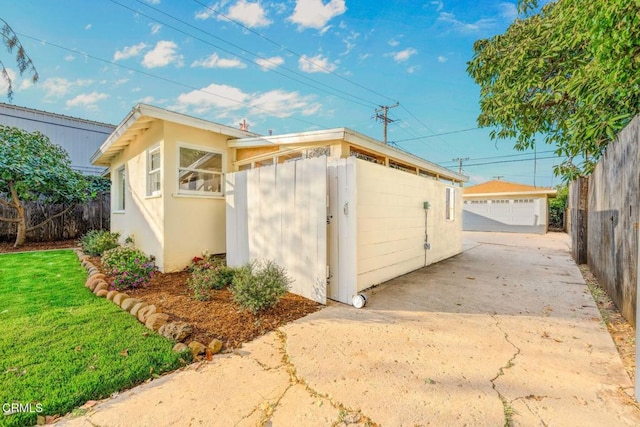 view of outbuilding featuring an outbuilding and fence