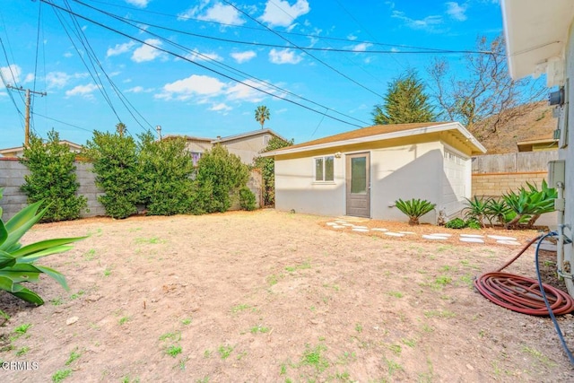 view of yard with an outbuilding and a fenced backyard