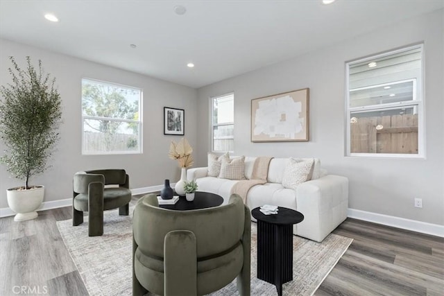 living room with recessed lighting, baseboards, and wood finished floors