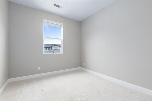 unfurnished room featuring light carpet, visible vents, and baseboards