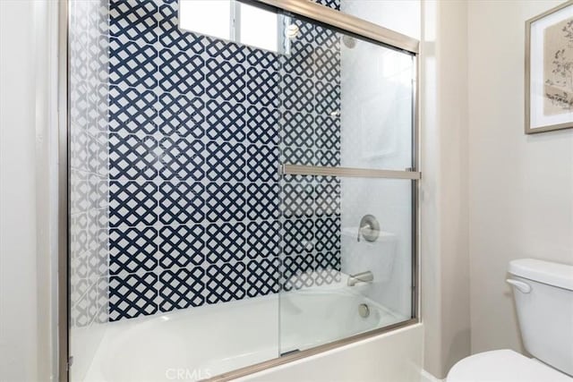 full bathroom featuring toilet and bath / shower combo with glass door