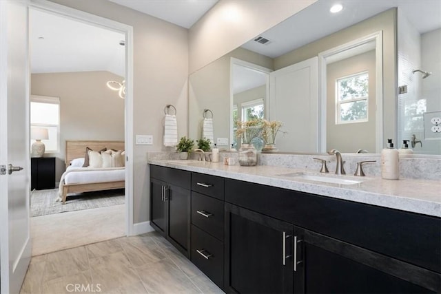 bathroom featuring double vanity, ensuite bath, visible vents, and a sink