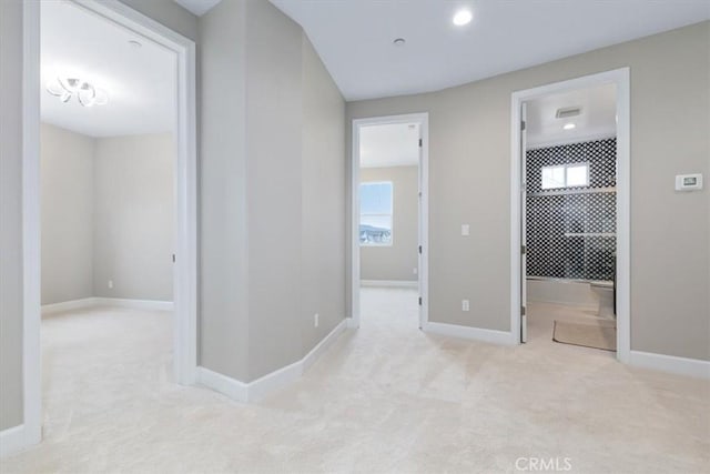 hall with carpet floors and baseboards