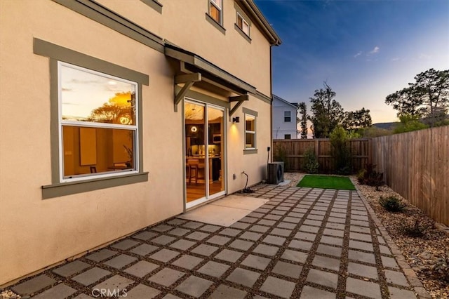 view of patio / terrace with cooling unit and a fenced backyard