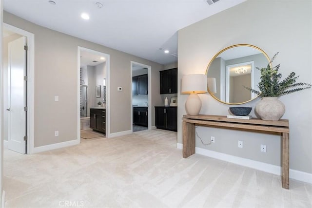 interior space with light carpet, baseboards, and recessed lighting