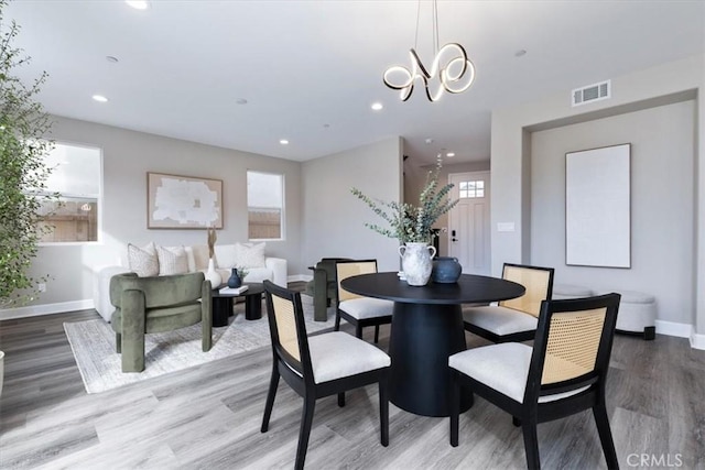 dining space with recessed lighting, wood finished floors, visible vents, baseboards, and plenty of natural light