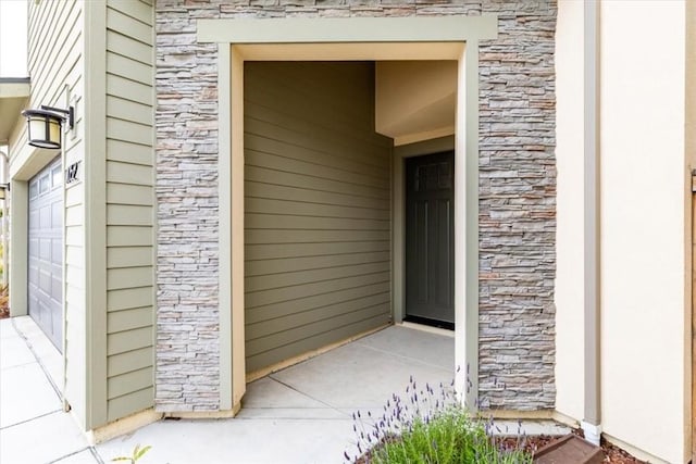 doorway to property with stone siding