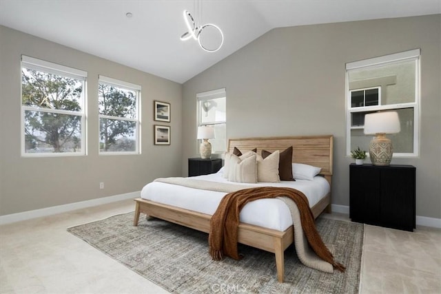 bedroom featuring baseboards, vaulted ceiling, and light colored carpet