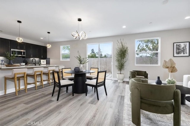 dining area featuring recessed lighting, light wood-style flooring, and baseboards