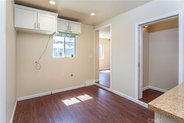 unfurnished bedroom with dark wood-style floors, baseboards, and recessed lighting