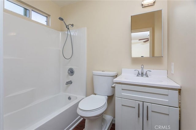 bathroom featuring toilet, shower / bath combination, and vanity