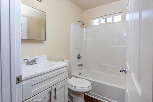 full bath featuring wood finished floors, shower / bathing tub combination, vanity, and toilet