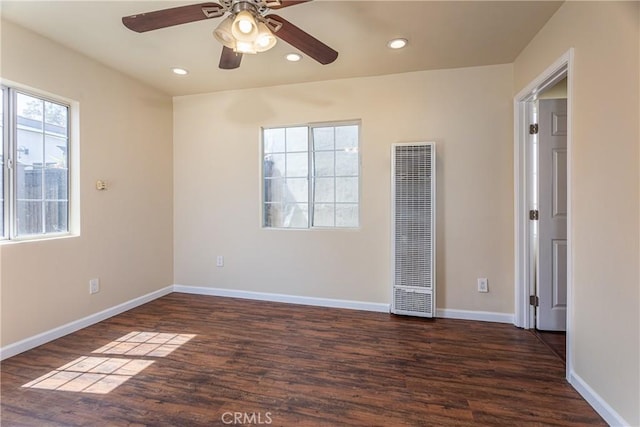 unfurnished room with baseboards, a heating unit, a ceiling fan, wood finished floors, and recessed lighting