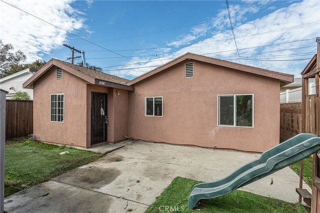 back of property with a patio area, fence, and stucco siding